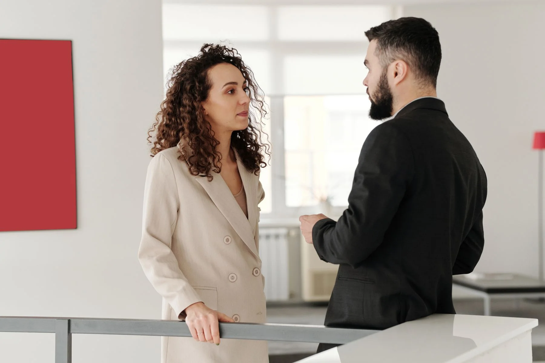 Two professionals discussing a hiring brief in a bright office